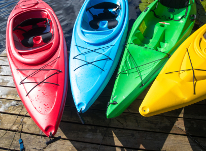 row of colorful kayaks on a pier