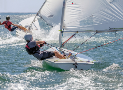 two people windsurfing on lake