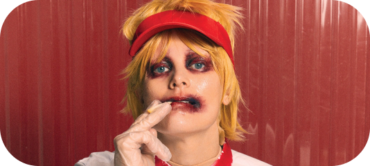 Karin Dreijer as Fever Ray dressed as a fast food employee